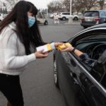 Pitman school employee Maria Johnson gives out COVID-19 rapid self test kits to students accompanied by a parent at Pitman High School in Turlock, Calif., on Thursday, Jan. 13, 2022. ANDY ALFARO AALFARO@MODBEE.COM