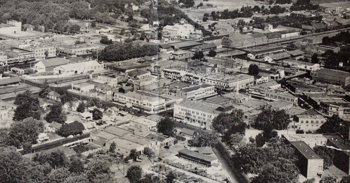 Historic aerial photograph of downtown Turlock, with the railway, streets, buildings and surrounding fields in 1936.