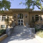 The historic Carnegie building in Turlock, with arched windows and steps leading to the entrance.
