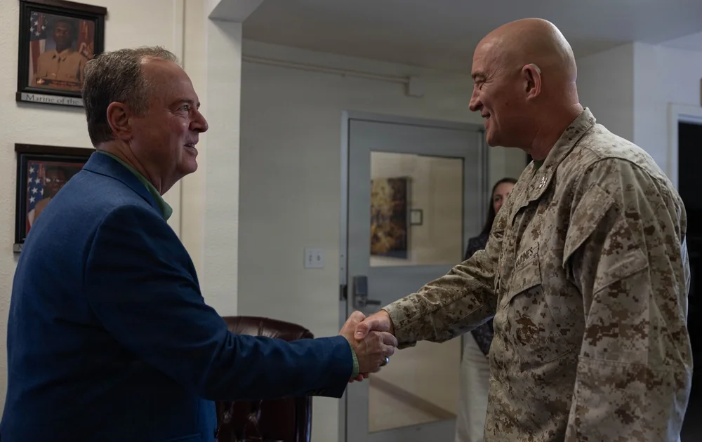 Adam Schiff shaking hands with Colonel Ronald Storer during a Marine Corps installation visit at Twentynine Palms in May 2026.