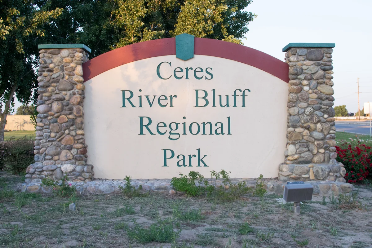Stone pillars frame the Ceres River Bluff Regional Park entrance sign.