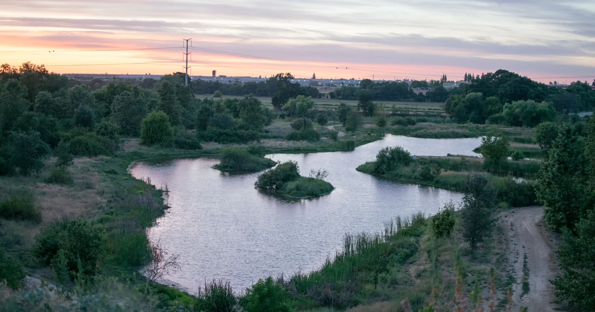 The winding pond below the bluff at Ceres River Bluff Regional Park at sunset.