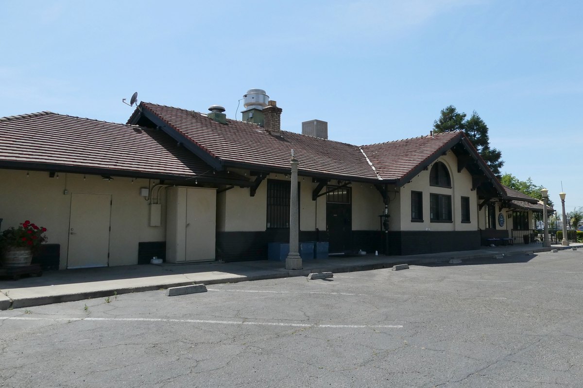 The former Southern Pacific railroad depot in downtown Turlock, with its tiled roof and broad eaves.
