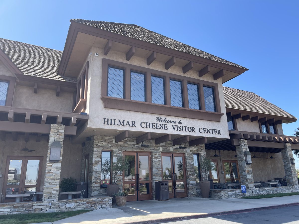 Exterior of Hilmar Cheese Company Visitor Center, showing its entrance and name above the doors.