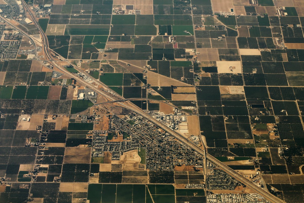 Aerial view of Keyes, California, with Highway 99, neighborhoods and farmland in 2014