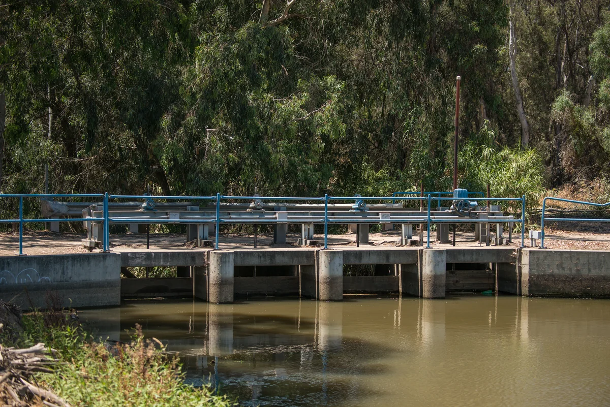 Water gates and an irrigation waterway near Livingston, California, photographed in July 2015.