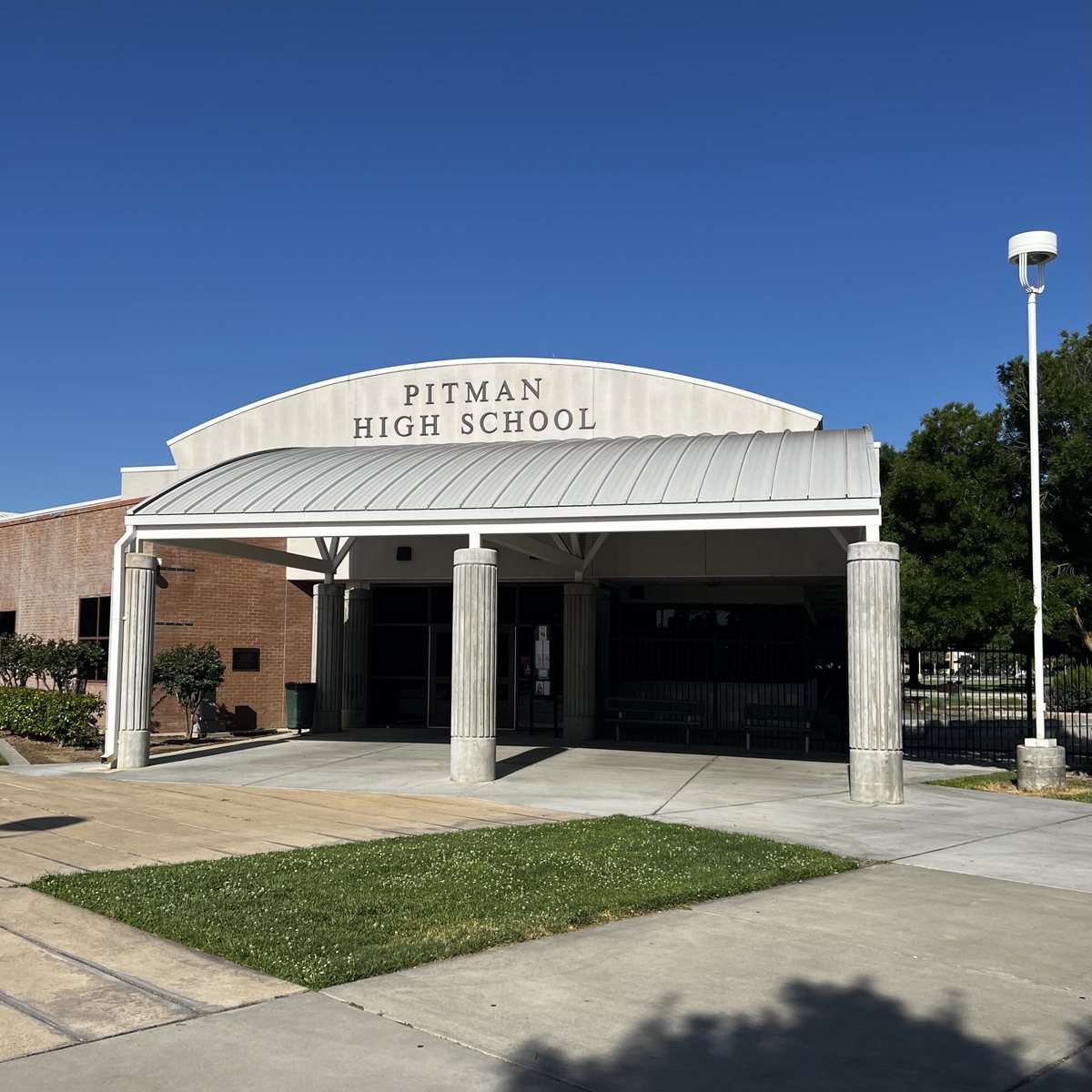 The front office entrance of Pitman High School in Turlock, with the school name above its columned canopy.