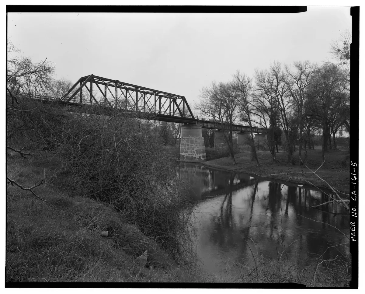 Historic railway bridge over the Stanislaus River at Riverbank, with trees and Jacob Myers Park on the right in 1995