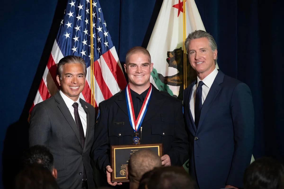 Rob Bonta and Gavin Newsom present a Medal of Valor to San Bernardino Police Officer Gabriel Rodriguez on June 18, 2025.